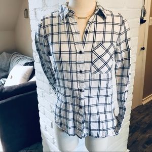 Plaid, white and black buttoned down shirt.